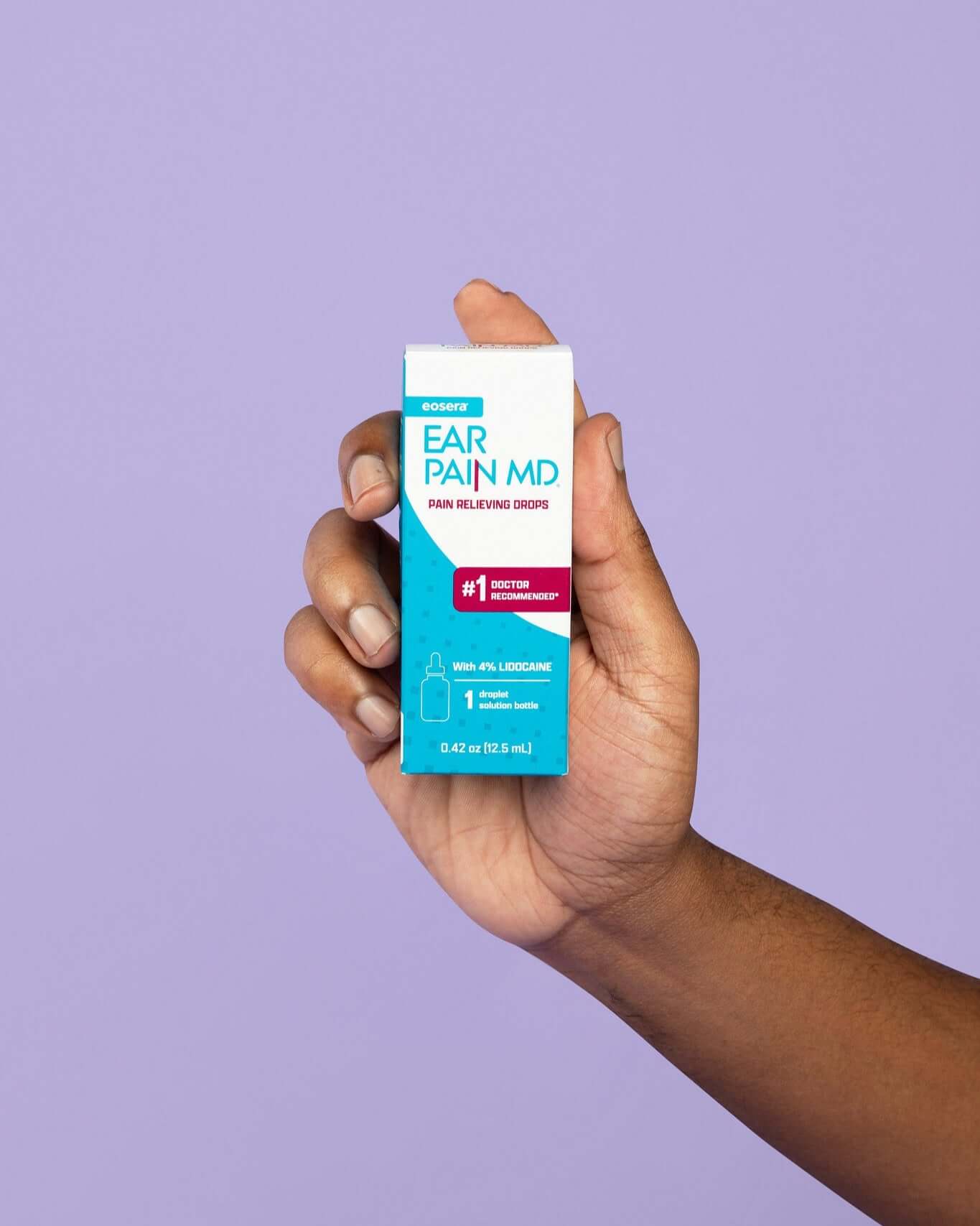 Hand holding Ear Pain MD pain relieving drops on a purple background, showcasing the product prominently.